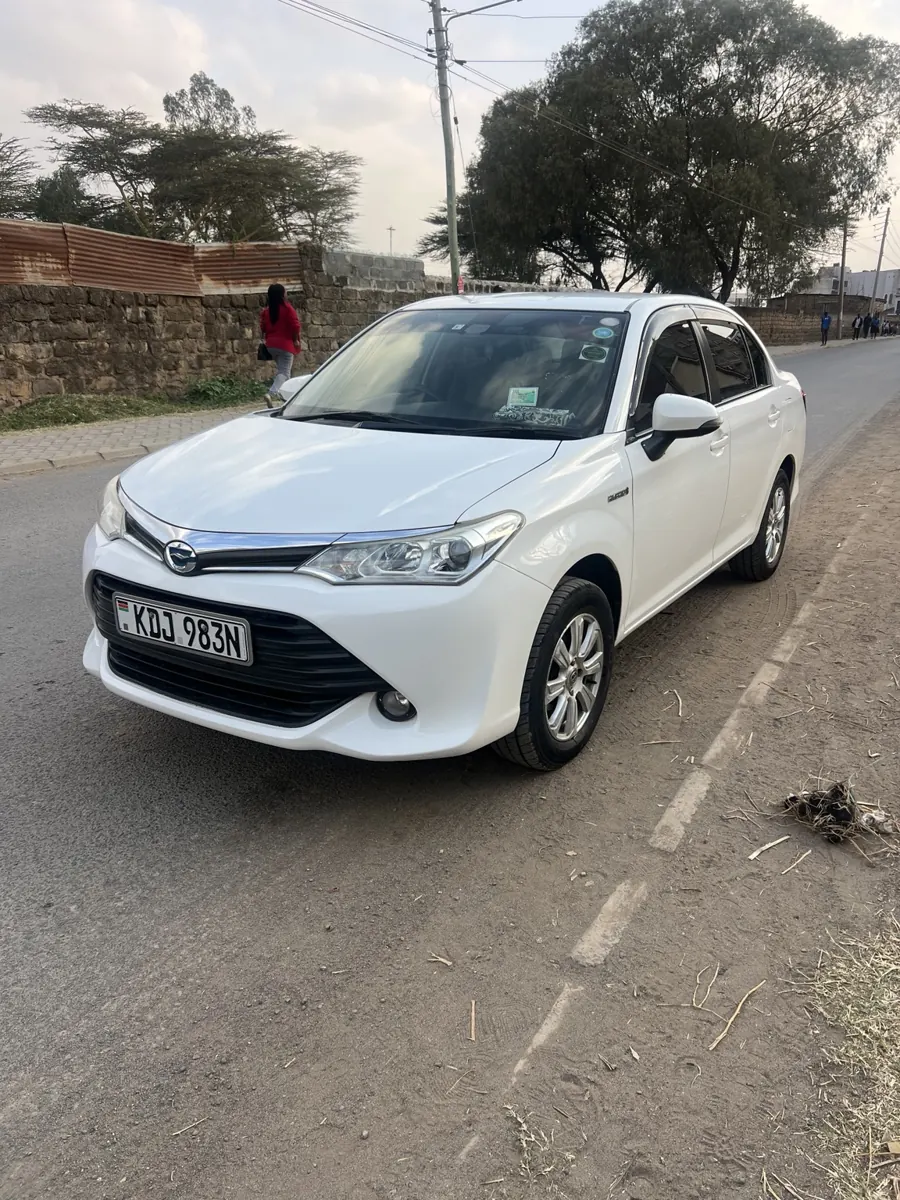 2016 white Toyota Axio Hybrid: front three-quarter view
