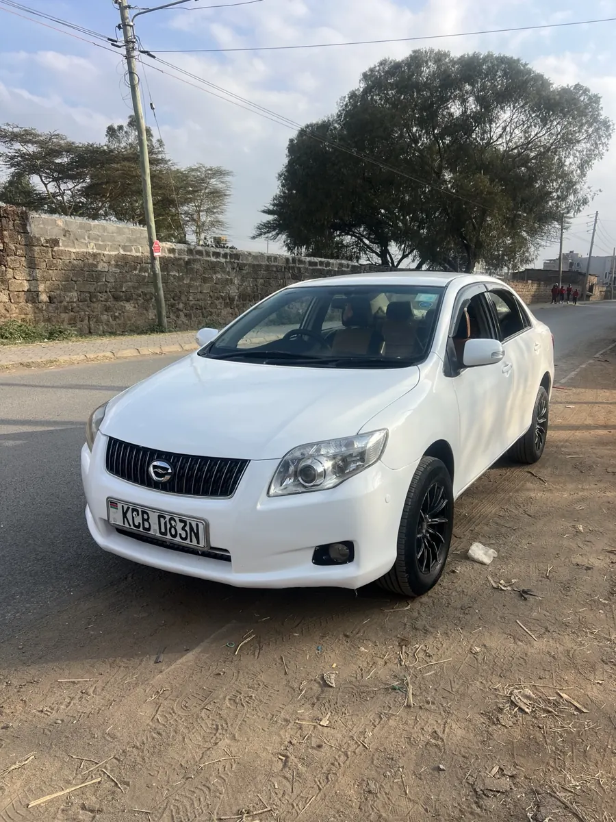 White Toyota Axio Luxel: front three-quarter view