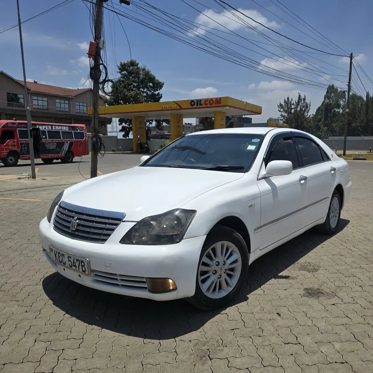 White Toyota Crown KCC 547B — front three-quarter view