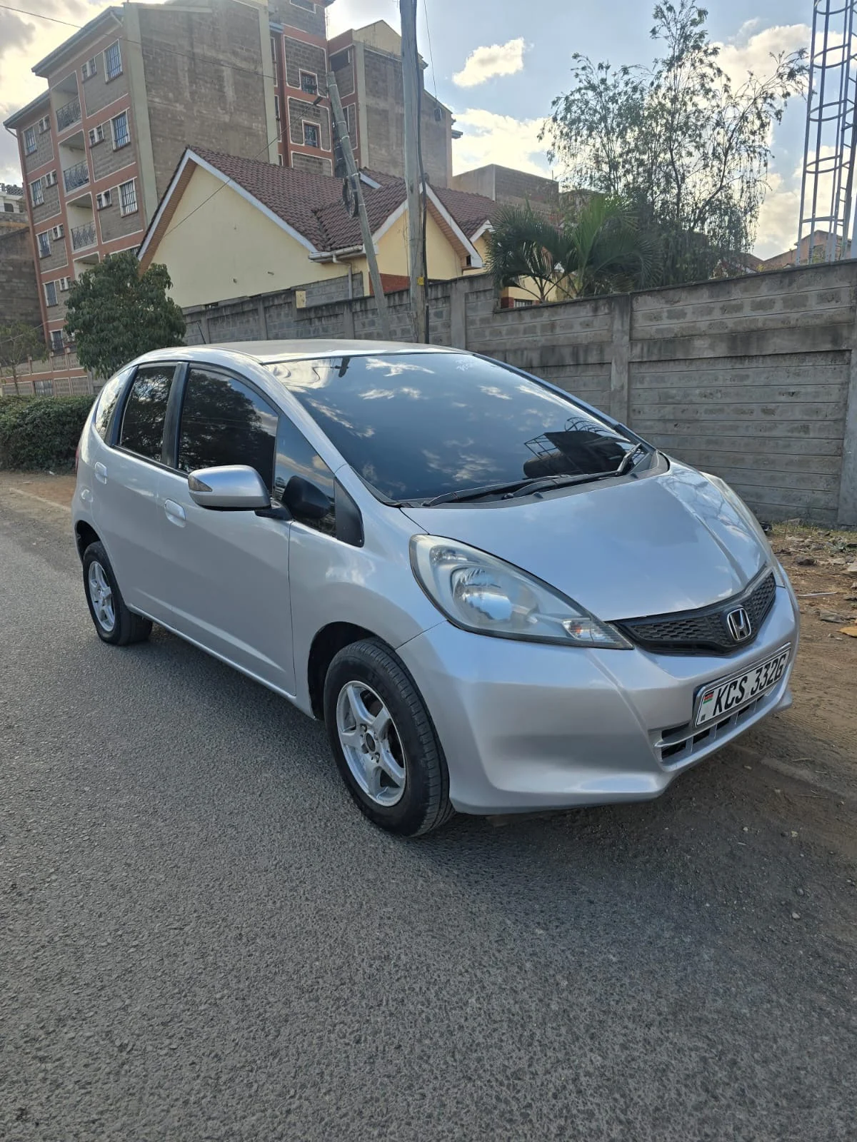 Silver Honda Fit KCS 332G — front three-quarter view