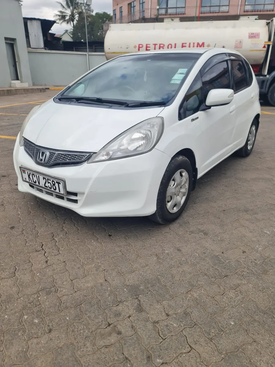 White Honda Fit: front left angle