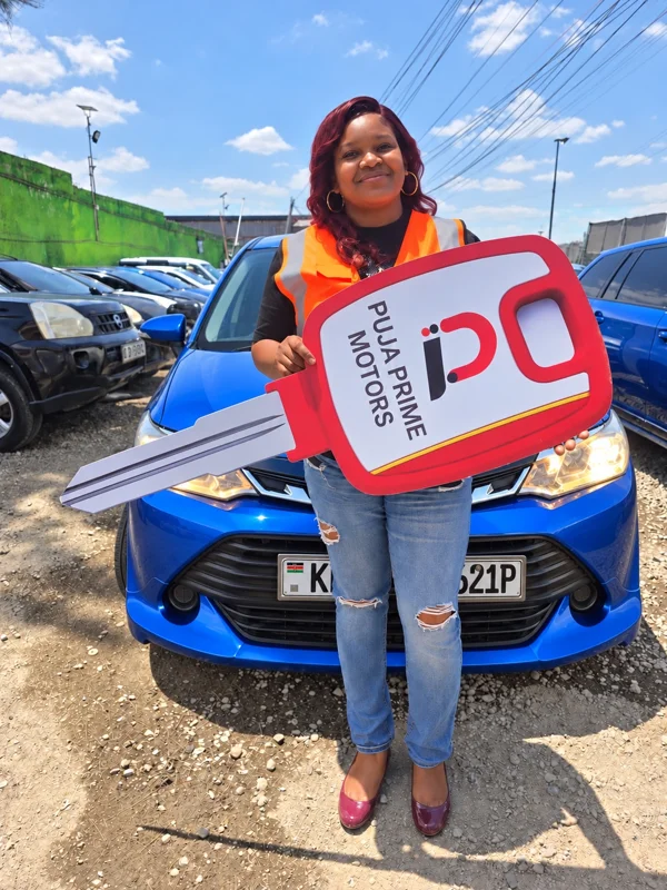 Joy at Puja Prime Motors in Donholm holding the branded car key