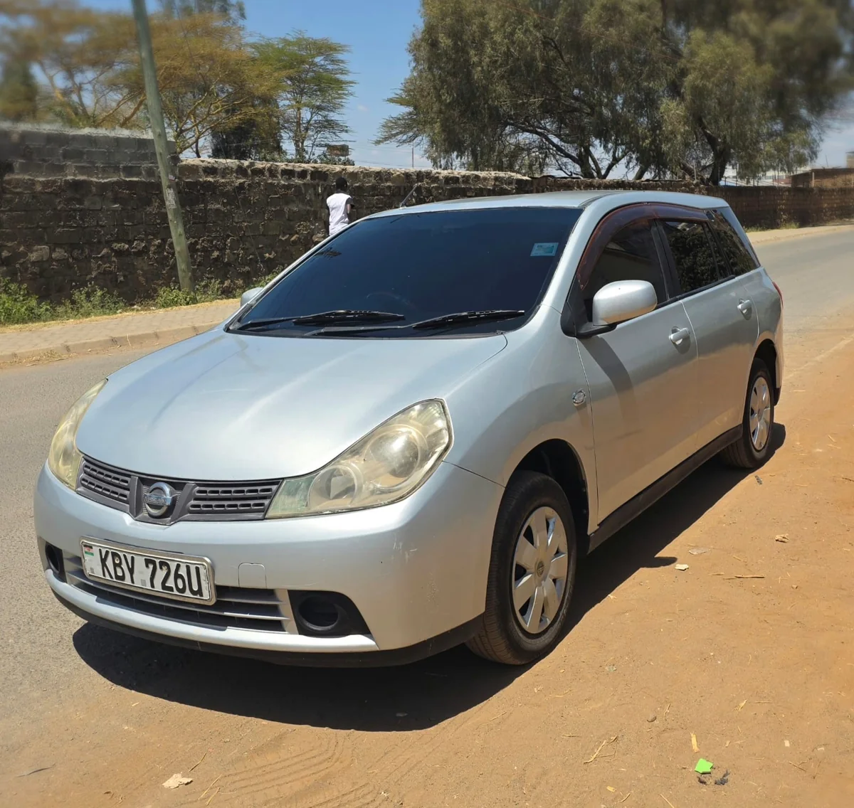 Silver Nissan Wingroad KBY 726U: front three-quarter view